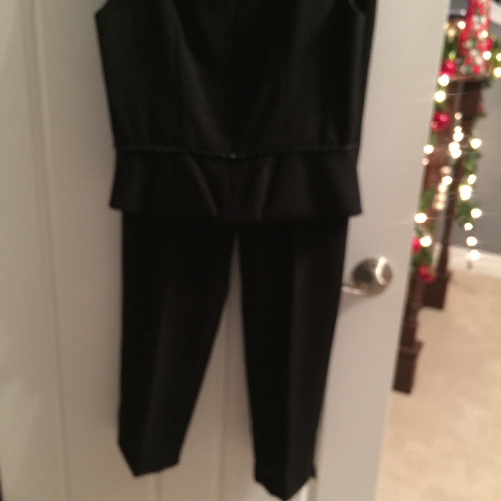 Classic black cigarette pants with sleeveless top.
